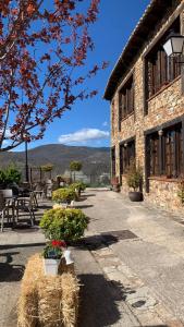 Prádena del Rincón的住宿－Al Viento, Alojamiento & Turismo Rural Prádena del Rincón，前面有干草包的建筑