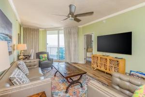 a living room with a couch and a flat screen tv at Palacio Unit 805 in Pensacola