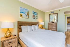 a bedroom with a large bed and two night stands at Palacio Unit 805 in Pensacola +21 photos