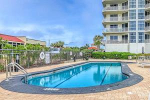 a swimming pool in front of a building at Palacio Unit 805 in Pensacola