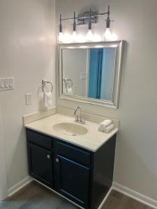 a bathroom with a sink and a mirror at Pack your bags and leave tonight! in Wilmington