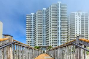 a wooden bridge with tall buildings in the background at Palacio Unit 805 in Pensacola