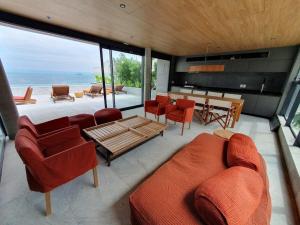 a living room with a couch and chairs and a table at Flat Av. Atlantica em frente ao mar, estrutura total in Rio de Janeiro
