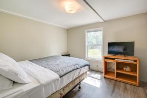 1 dormitorio con 1 cama y TV de pantalla plana en New Lisbon Family Gem about 3 Mi to Castle Rock Lake, en New Lisbon