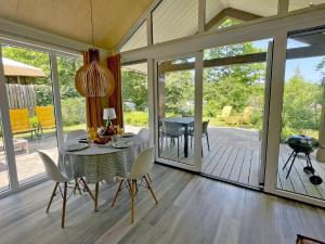 a dining room with a table and chairs at Nice chalet with garden at the Utrechtse Heuvelrug in Rhenen