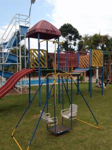 a playground with a slide in a park at Chácara 4 Ases J R in Cotia