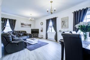 a living room with a couch and a table at Modern 2-Bedroom - 2 Bathroom Apartment in Waltham Abbey-Gated Car Park-Fast Internet in Waltham Abbey