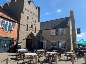 a group of tables and chairs in front of a building at Salty Dog at The Bay Filey, sleeps 4, 2 dogs welcome for free too in Filey