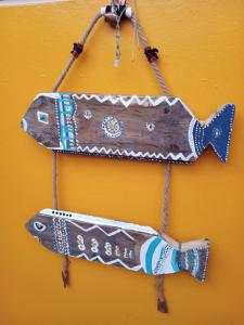 two wooden fish ornaments hanging on a wall at Hostal Maria Casa in La Serena