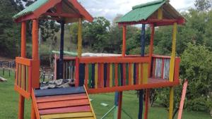 a playground with a colorful play structure in a park at casa donna zilda in Extrema