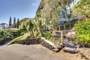 a house with a stone staircase in front of a building at Luxury Kailua Home with Views - Walk to Beaches! in Kailua