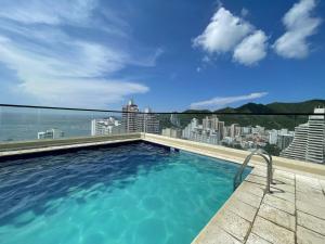 a swimming pool on the roof of a building at En el Rodadero Santa Marta apto Moderno con piscina,sauna,turco,Jacuzzi in Rodadero