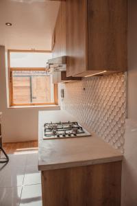 a kitchen with a stove top oven next to a window at Casa Faustina - Templo de la Luna in Cusco