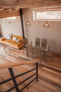 a living room with a couch and a table and chairs at Casa Faustina - Templo de la Luna in Cusco