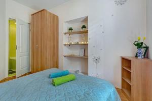 a bedroom with a bed with a green pillow on it at Private Entrance-2 ROOMS-OLD TOWN- Free Parking in Vilnius