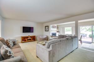 a living room with a couch and a tv at Tucson Townhome with Shared Pool in 55 and Community! in Tucson