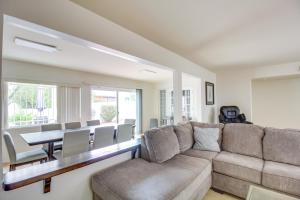 a living room with a couch and a table at Tucson Townhome with Shared Pool in 55 and Community! in Tucson