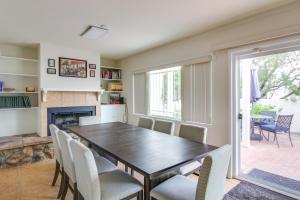 a dining room with a table and chairs and a fireplace at Tucson Townhome with Shared Pool in 55 and Community! in Tucson