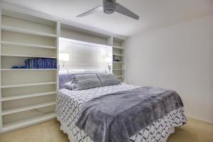 a bedroom with a bed and a ceiling fan at Tucson Townhome with Shared Pool in 55 and Community! in Tucson