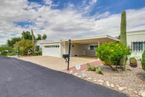 a house with a white garage and a driveway at Tucson Townhome with Shared Pool in 55 and Community! in Tucson
