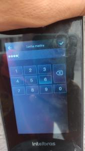 a persons hand holding a tablet computer with the settings at Apartamento Novinho Aeroporto JF in Juiz de Fora