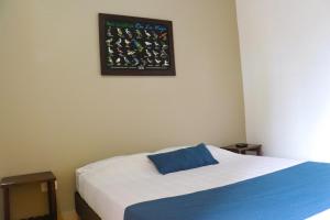 Ein Bett oder Betten in einem Zimmer der Unterkunft Hotel Quindio Campestre