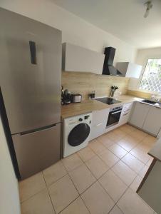 a small kitchen with a sink and a refrigerator at les Aliceas appartement cosy in Baie-Mahault