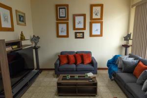 uma sala de estar com um sofá e uma televisão em “Casa W-J” Entire flat#1 /Doesn't flood. 2 garages em Guayaquil