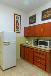 a kitchen with a white refrigerator and a microwave at “Casa W-J” Entire flat#1 /Doesn't flood. 2 garages in Guayaquil