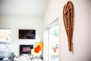 a mirror hanging on a wall in a living room at Reved Up & Out - Remarkable Two Bedroom Condo in Revelstoke