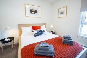a bedroom with a bed with towels on it at Reved Up & Out - Remarkable Two Bedroom Condo in Revelstoke