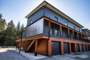 a large building with a balcony on the side of it at Reved Up & Out - Remarkable Two Bedroom Condo in Revelstoke