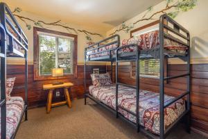 ein Schlafzimmer mit Etagenbetten und einem Tisch mit einer Lampe in der Unterkunft Bear Creek Resort in Big Bear Lake + 274 Fotos