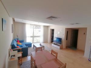 a living room with a blue couch and a table at Mangarovy El Gouna in Hurghada