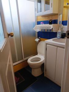 a small bathroom with a toilet and a sink at Casa de campo Pillaro - Activa in Píllaro