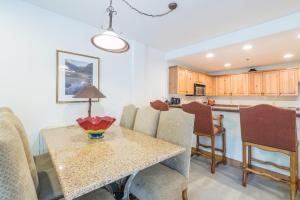 a kitchen and dining room with a table and chairs at Bear Creek Lodge 110A in Telluride