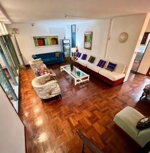 an aerial view of a living room with a couch and chairs at La Casa del Viajero in Lima