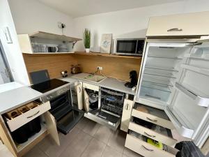 a kitchen with an open refrigerator with its door open at Tiny Ferienhaus Greizer Str 26 in Reichenbach im Vogtland