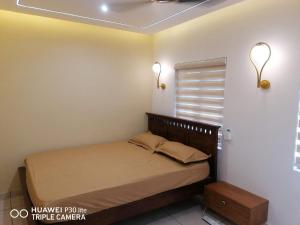 a bedroom with a bed in a room with a window at Thekkumbath Sea Breeze Pool villa in Kannur