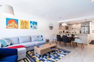 a living room with a couch and a table and a kitchen at Rocky Ridge Getaway - Modern Getaway in Revelstoke in Revelstoke