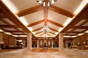 a large lobby with a christmas tree in the center at Sheraton Changbaishan Resort in Fusong