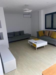 a living room with a couch and a coffee table at Apartment in Soukra in Tunis