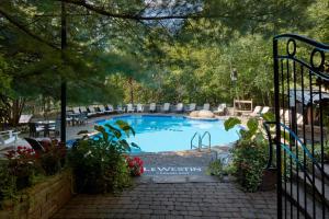 a large swimming pool with chairs and a fence at Le Westin Tremblant in Mont-Tremblant