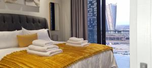 a pile of towels sitting on top of a bed at Ellipse Waterfall City Luxury Apartment - Bigger Apartment than Most, 9th Floor in Midrand