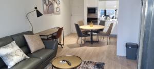 a living room with a couch and a table at Ellipse Waterfall City Luxury Apartment - Bigger Apartment than Most, 9th Floor in Midrand