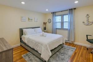 a bedroom with a large bed and a window at Boston Duplex with Foosball Table 11 Mi to Downtown in Boston