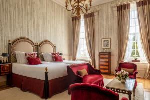 a bedroom with a large bed and two chairs at Tivoli Palácio de Seteais Sintra Hotel - The Leading Hotels of the World in Sintra