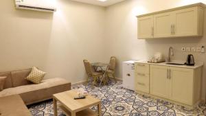 a living room with a couch and a table at شقق برج بيات للشقق الفندقية in Jazan