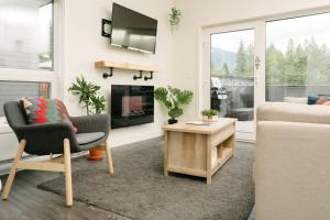 a living room with a couch and a chair at The Nest - Condo with Hot Tub & BBQ in Revelstoke