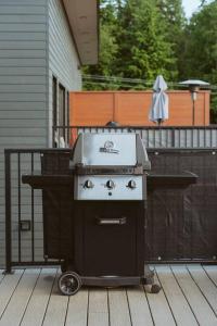a grill sitting on a deck on a porch at The Nest - Condo with Hot Tub & BBQ in Revelstoke